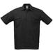 A black Mercer Culinary short sleeve cook shirt with buttons and pockets.