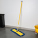 A yellow Lavex mop pad on the floor.