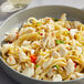 A bowl of pasta with Handy Jumbo Lump Crab Meat and vegetables.