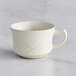 An Acopa ivory stoneware cup with a handle.