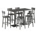 A Lancaster Table & Seating slate gray live edge bar height table with six bar stools around it.