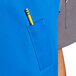 A person wearing a blue Uncommon Chef surge bib apron with black webbing and a pencil in the pocket.