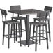 A Lancaster Table & Seating bar table with a live edge solid wood top and metal base with four bar chairs.