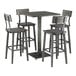 A Lancaster Table & Seating live edge bar height table with four bar stools.