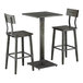 A square slate gray bar height table with a solid wood live edge and two matching bar stools.