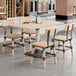 A bleached oak finish solid wood live edge table with four matching industrial-style chairs.