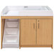 A maple wood toddler walkup changing table with a cabinet and drawers.