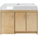 A natural birch plywood baby changing table with silver handles on a wooden cabinet.