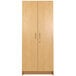 A Tot Mate maple wooden tall cabinet with two doors and handles.