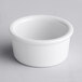 A close up of a Tuxton porcelain white ramekin.