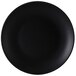 A black Tuxton china plate with a white background.