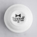 A stackable white Tuxton China ramekin.