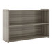 A wooden Tot Mate preschool storage shelf with two shelves.