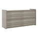A wooden Tot Mate toddler compartment storage cabinet in shadow elm with a white top.