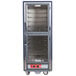 A large blue metal Metro C5 heated holding cabinet with clear Dutch doors.