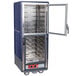 A large blue and silver Metro C5 heated holding cabinet with clear Dutch doors.