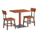 A Lancaster Table & Seating rustic mahogany wooden table with metal legs and two wooden chairs with metal frames.