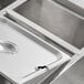 A stainless steel Avantco steam table adapter bar on a metal tray.