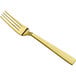 A close-up of a Bon Chef stainless steel dinner fork with a matte gold handle.