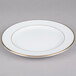 A CAC white porcelain plate with a gold rim.