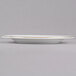 A CAC white porcelain plate with gold trim.
