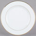 A CAC porcelain plate with a gold rim.