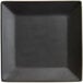 A black square stoneware plate with a white border.