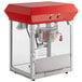 A red and silver Carnival King popcorn popper on a cart with a red lid.