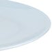 A close-up of a white Thunder Group oval melamine platter with a thin rim.