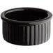 An Acopa glossy black fluted stoneware ramekin.