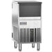 An Ice-O-Matic undercounter ice machine on a stainless steel counter.