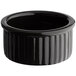 A glossy black fluted stoneware ramekin.