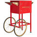 A red Carnival King popcorn cart with wheels.