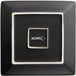 An Acopa matte black square stoneware plate with white trim.