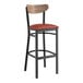 A Lancaster Table & Seating black bar stool with burgundy vinyl seat and wood backrest.