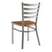 A Lancaster Table & Seating metal chair with a wood seat and ladder back.