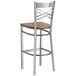 A Lancaster Table & Seating cross back bar stool with a wood seat.