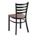 A ladder back chair with a distressed copper finish and a vintage wood seat.