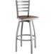 A Lancaster Table & Seating swivel bar stool with a wooden seat and metal frame.