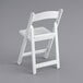 a white folding chair on a gray background