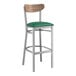 A Lancaster Table & Seating bar stool with a green vinyl seat and wood back.