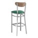 A Lancaster Table & Seating bar stool with a green vinyl seat and wood back.