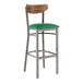 A Lancaster Table & Seating bar stool with a green vinyl seat and metal legs.