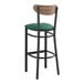 A Lancaster Table & Seating black bar stool with green vinyl seat and vintage wood back.