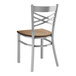 A Lancaster Table & Seating metal chair with a wooden seat and back.