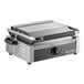 A stainless steel panini and sandwich grill with grooved plates and a temperature control knob.