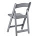 A gray resin folding chair with a slatted seat and backrest.