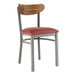 A Lancaster Table & Seating metal chair with a red vinyl seat and vintage wood back.