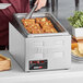 A ServIt stainless steel angled display adapter on a hotel buffet counter.