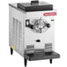A silver SaniServ countertop ice cream machine with a black lid.